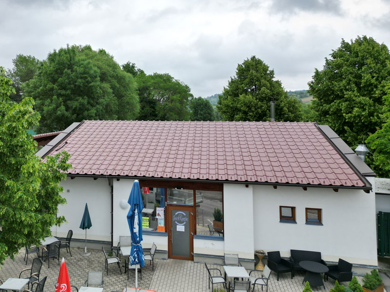 Teichkantine Rohrbach Dachsanierung nach Wassereintritt, Dacherneuerung Structa Dachplatte, wegen geringer Dachneigung notwendig - braune Hängerinne, Umdeckung eines alten Daches, Dach rot rotbraun Vorbereitung für Photovoltaik-Anlage, neues Dach